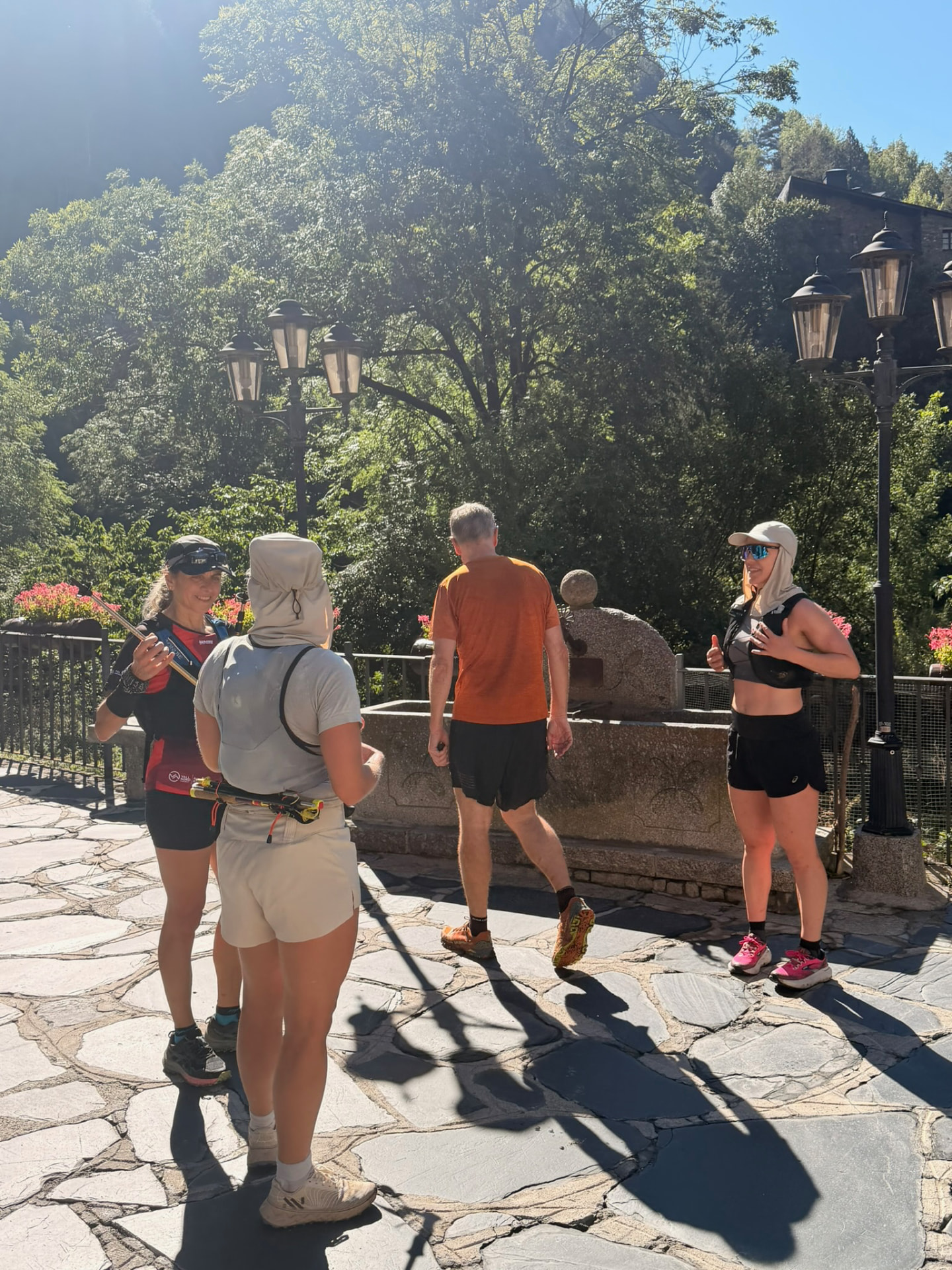 Run the Pyrenees runners gathering by the stone fountain in Ordino before a morning run