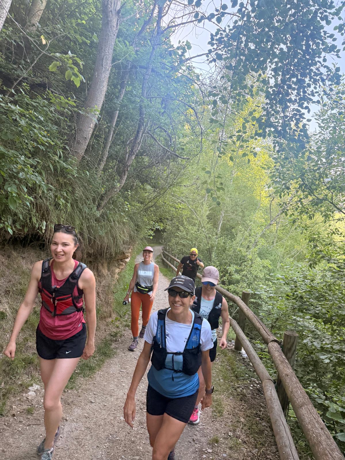 Smiling group of trail runners on a grassy path in Andorra