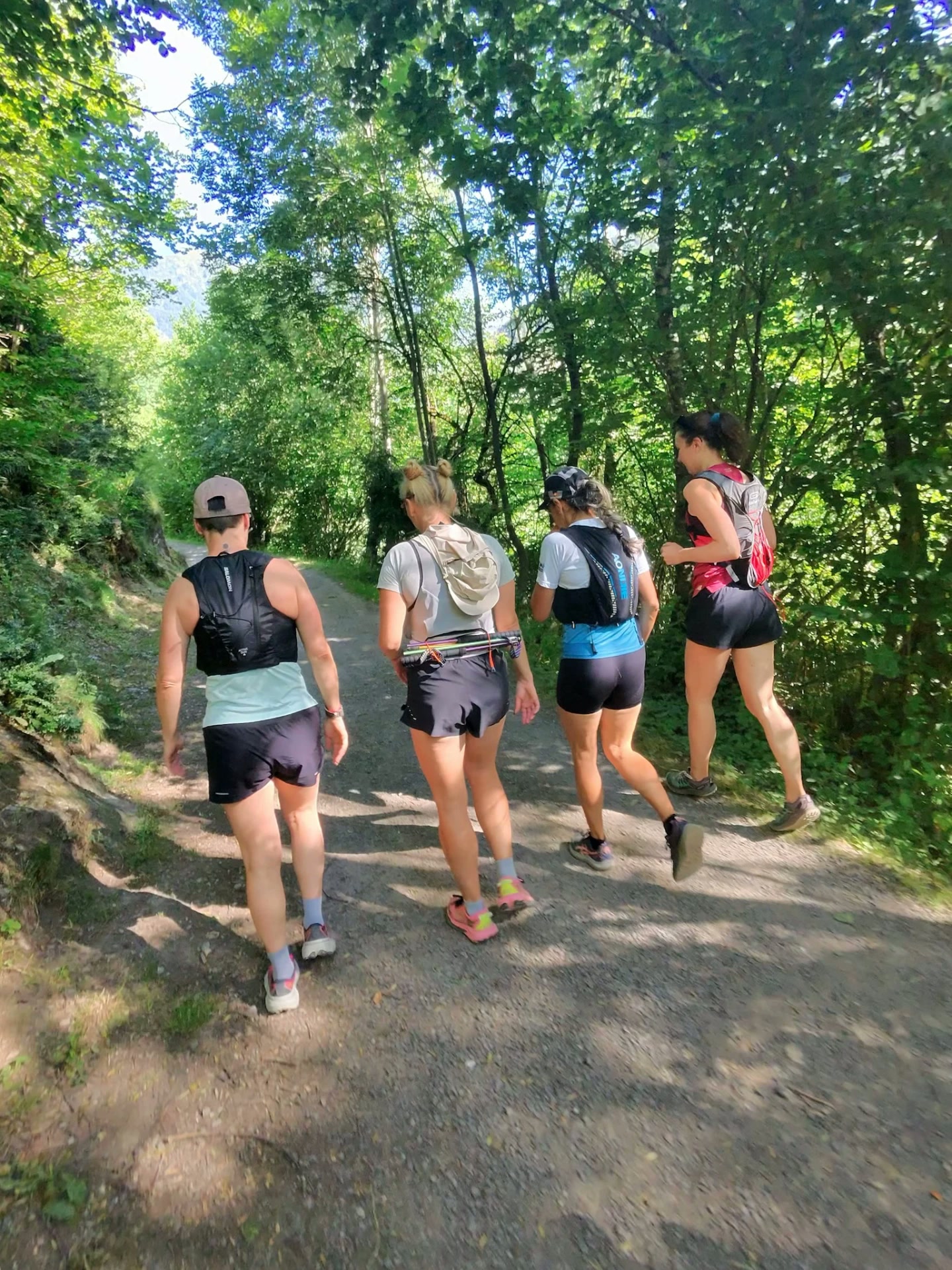 Relaxed group of trail runners on a forest path in Andorra