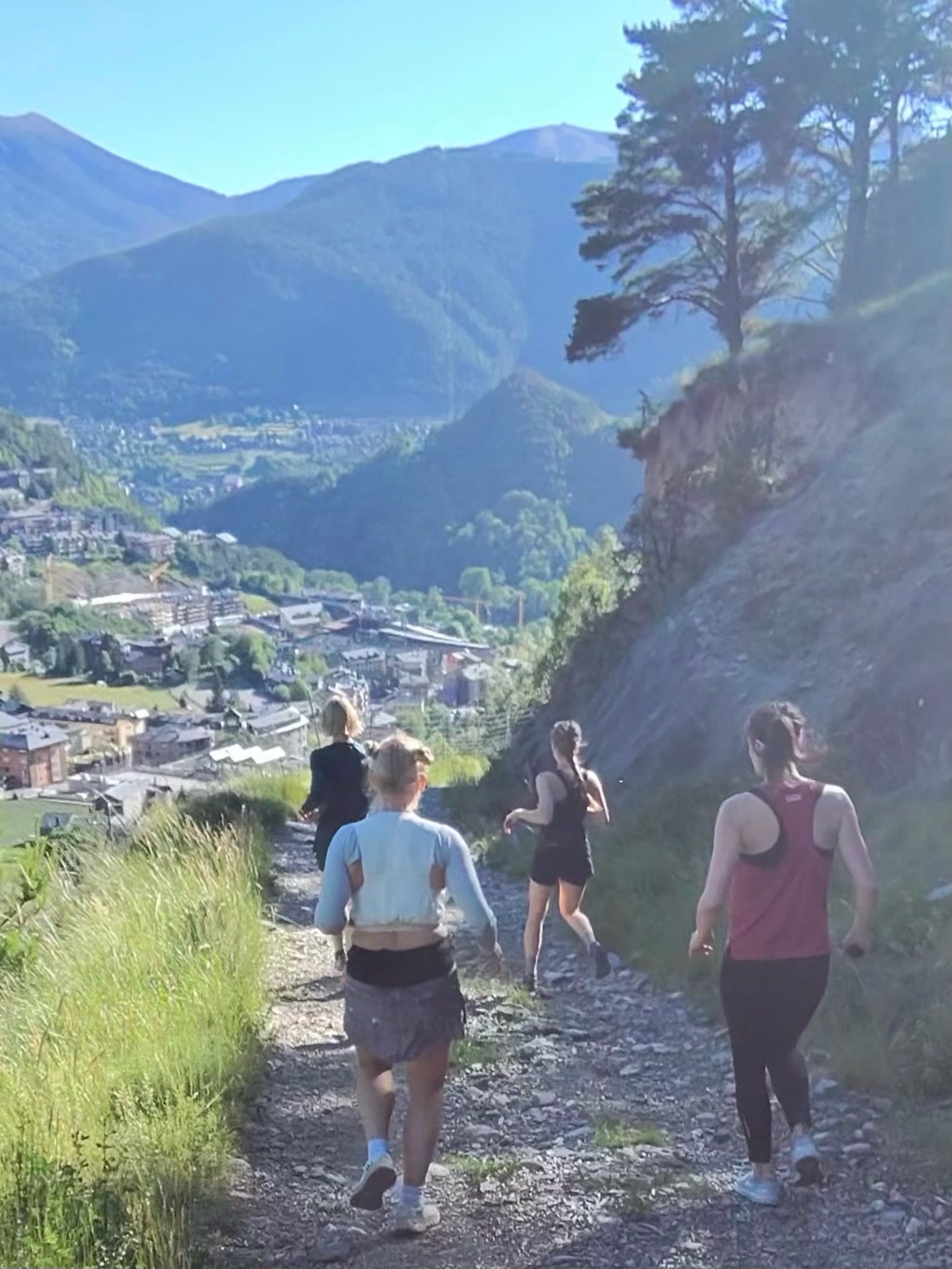 Trail runners above Ordino, Andorra, with the Pyrenees behind them
