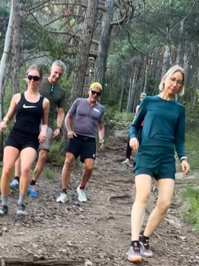Group running together up a forest trail in Andorra